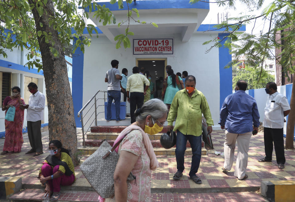 People wearing masks as a precaution against the coronavirus wait for their turn to be administered COVISHIELD vaccine at a government hospital in Hyderabad, India, Monday, April 19, 2021. (AP Photo/Mahesh Kumar A.)