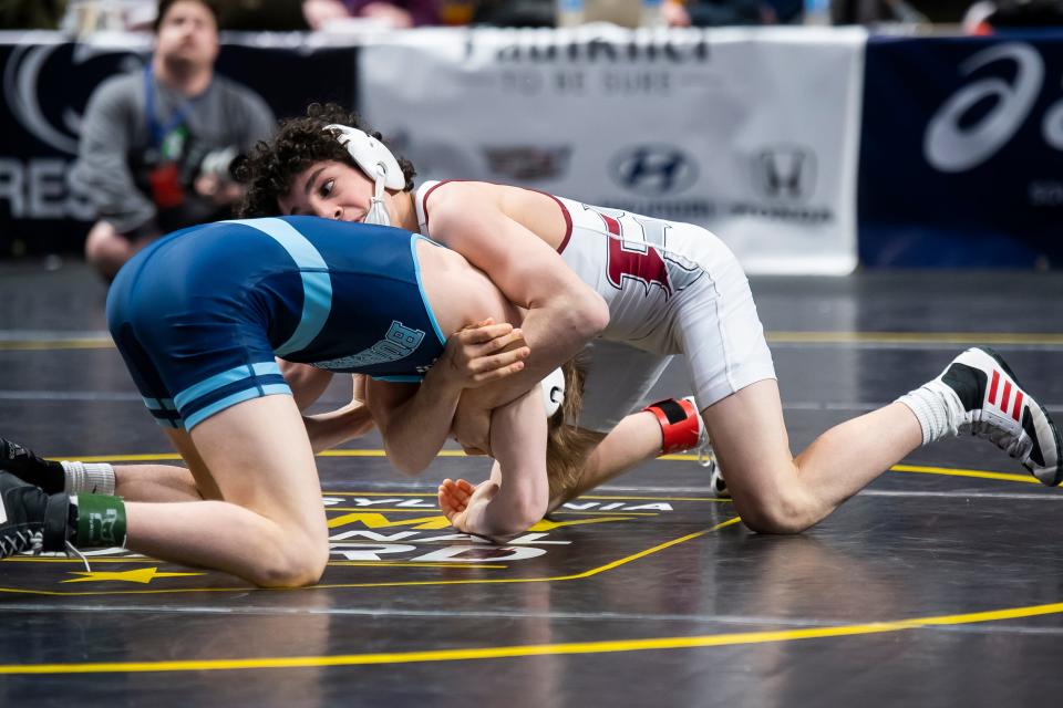 Faith Christian's Joey Bachmann (right) wrestles Burrell's Cam Baker in a 107-pound semifinal bout during the PIAA Class 2A Wrestling Championships at the Giant Center on March 8, 2024, in Hershey. Bachmann won by tech fall, 20-5, at 5:33.