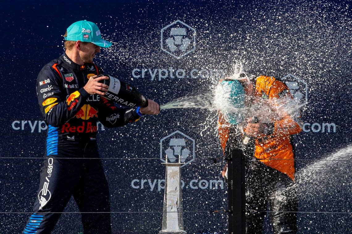 McLaren driver Lando Norris of Britain, right, who placed First is sprayed with champagne by Red Bull Racing driver Max Verstappen of Netherlands, left, who placed second in the Formula One Miami Grand Prix.