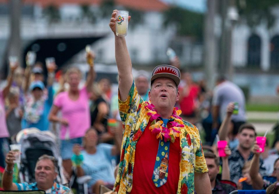 Britt Deviney raises his glass to toast the late Jimmy Buffett during a special "Clematis by Night Celebrates Jimmy Buffett" in West Palm Beach on September 28, 2023.