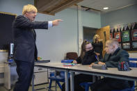 FILE - In this Wednesday, Aug. 26, 2020 file photo, Britain's Prime Minister Boris Johnson gestures during a visit to Castle Rock school on the pupils' first day back, in Coalville, East Midlands, England. Johnson is announcing plans Monday, Feb. 22, 2021 to ease restrictions in increments, starting by reopening schools in England on March 8. People will be allowed to meet one friend or relative for a chat or picnic outdoors from the same day. Three weeks later, people will be able to meet outdoors in groups of up to six outdoors. But restaurants, pubs, gyms and hairdressers are likely to remain closed until at least April. (Jack Hill/Pool Photo via AP, File)