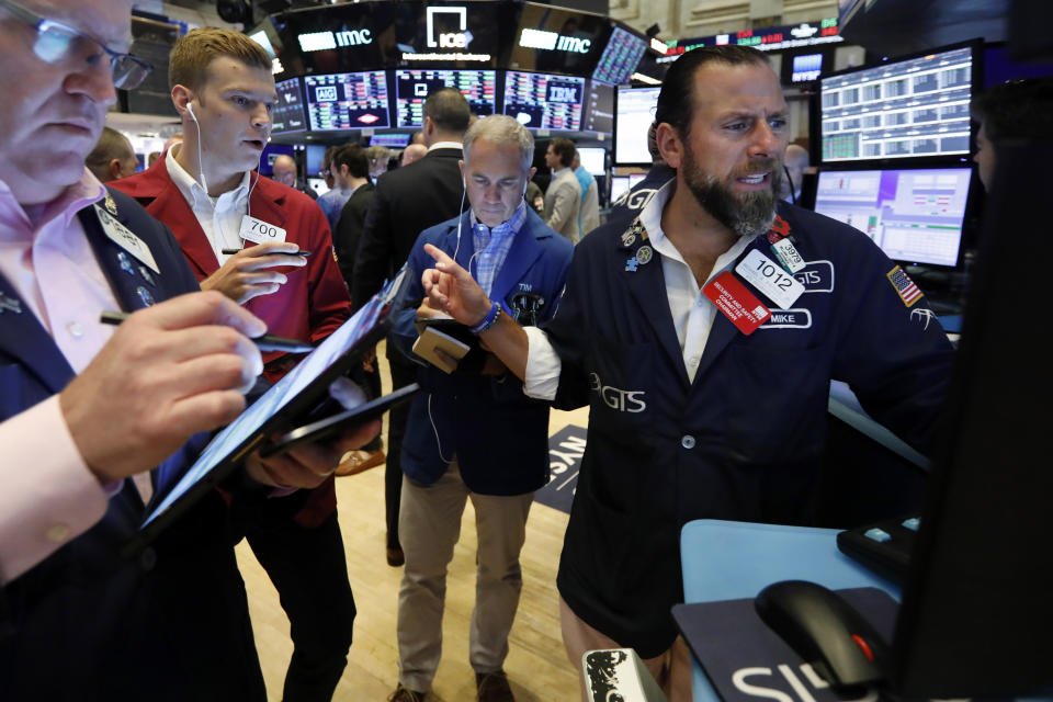 Specialist Michael Pistillo, right, works with traders at his post on the floor of the New York Stock Exchange, Friday, July 19, 2019. U.S. stocks moved broadly higher in early trading on Wall Street Friday and chipped away at the week's losses. (AP Photo/Richard Drew)