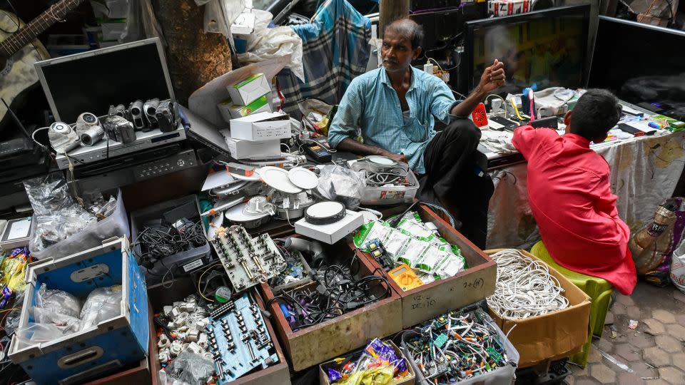 A man selling electronic goods at a e-waste market place in Kolkata, India, in June 2022. - Debarchan Chatterjee/NurPhoto/Getty Images