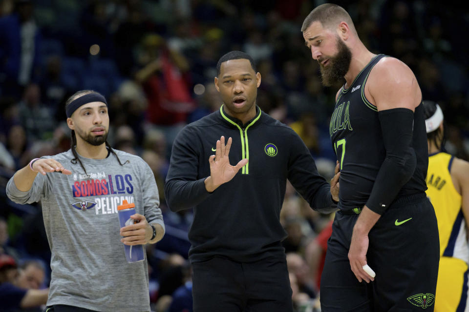 New Orleans Pelicans coach Willie Green talks to center Jonas Valanciunas, right, during the first half of the team's NBA basketball game against the Indiana Pacers on Friday, March 1, 2024, in New Orleans. (AP Photo/Matthew Hinton)