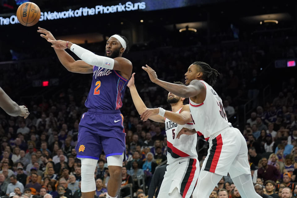 Phoenix Suns forward Josh Okogie (2) passes as Portland Trail Blazers guard Skylar Mays (5) defends during the second half of an NBA In-Season Tournament basketball game, Tuesday, Nov. 21, 2023, in Phoenix. (AP Photo/Matt York)