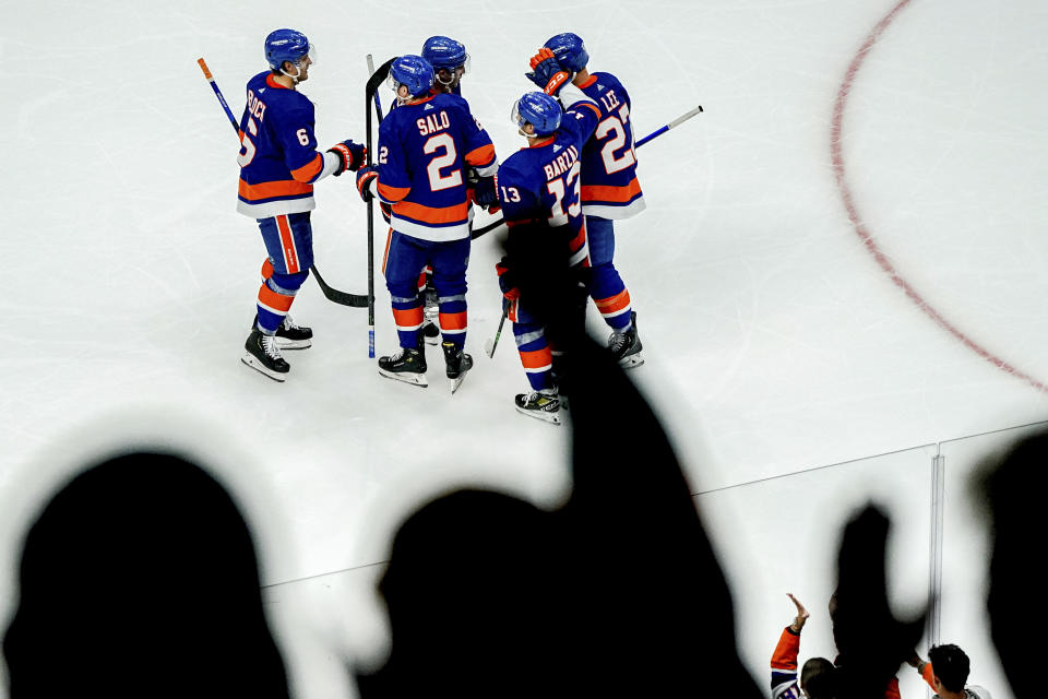 CORRECTS TO SATURDAY NOT THURSDAY - New York Islanders fans cheer after defenseman Robin Salo (2) scored a goal during the third period of an NHL hockey game against the Anaheim Ducks, Saturday, Oct. 15, 2022, in Elmont, N.Y. (AP Photo/Julia Nikhinson)