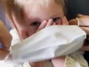 <p>In a video posted on social media the couple can be seen struggling with the 2-year-old to make her wear the mask before being asked to get off the flight</p> (Screengrab)