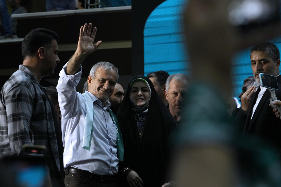 Iranian presidential candidate Masoud Pezeshkian waves to his supporters while campaigning in Tehran, Iran, Sunday, June 23, 2024. (AP Photo/Vahid Salemi)