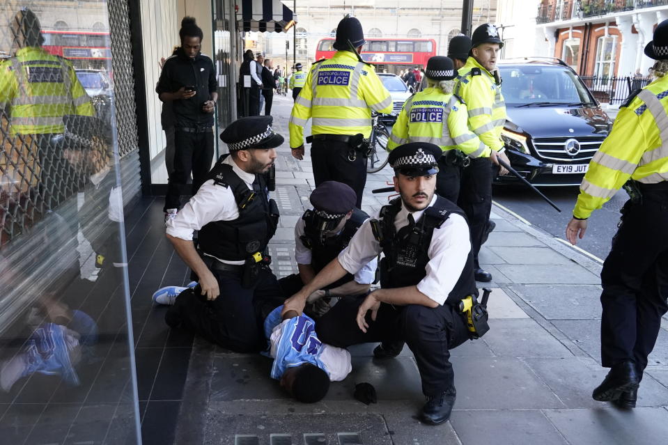 Police officers detain a man near Oxford Street following reports of planned disorder. (PA)