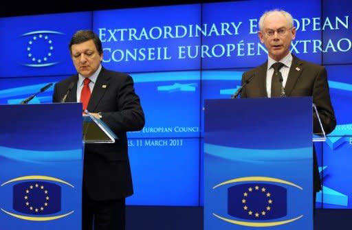 European Commission President Jose Manuel Barroso (L) and European Council President Herman Van Rompuy speak after the EU summit on Libya. Libyan leader Moamer Kadhafi must give up power "without delay", European Union leaders have said after the crisis summit
