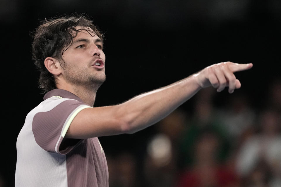 Taylor Fritz of the U.S. celebrates after defeating Stefanos Tsitsipas of Greece in their fourth round match at the Australian Open tennis championships at Melbourne Park, Melbourne, Australia, Sunday, Jan. 21, 2024. (AP Photo/Alessandra Tarantino)