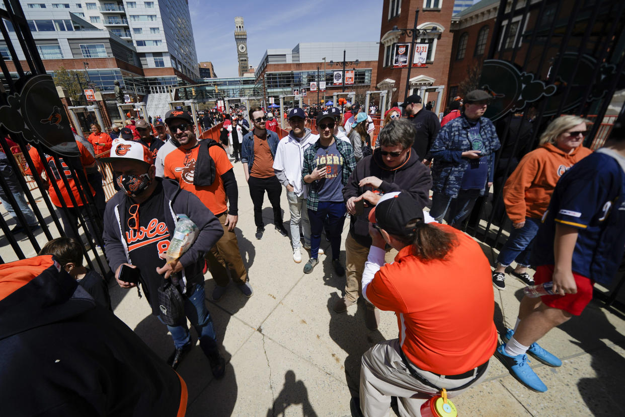 Spectators walk through the gates prior to a baseball game between the Baltimore Orioles and the Milwaukee Brewers on April 11. (AP Photo/Julio Cortez)