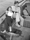 <p>Dolores del Río and Orson Welles enjoy a day on the water, making use of the stern of their ship for a photo op. The actress casually places her foot on the wheel of the ship, as Welles smokes a pipe. </p>