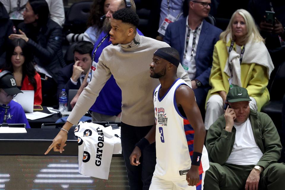 Coach Giannis Antetokounmpo of Team Dwyane Wade talks with tennis player Frances Tiafoe during the NBA celebrity all-star game Friday night.