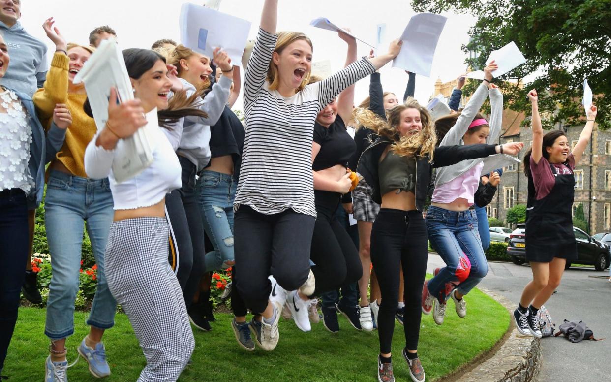 Students celebrate their A-level results at Brighton College in East Sussex - PA