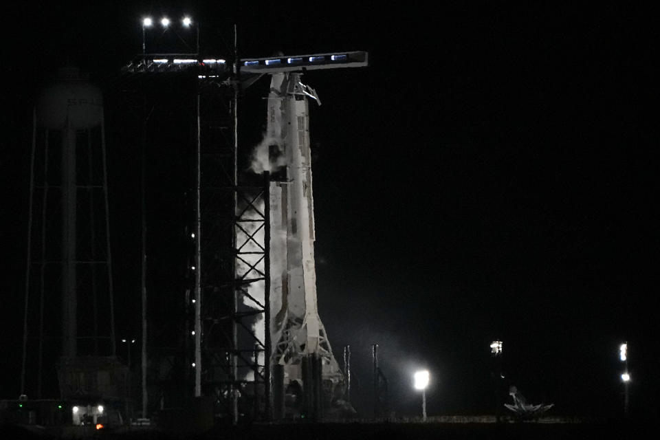 A SpaceX Falcon 9 rocket with the crew capsule Endeavour sits on pad 39A after the launch attempt was scrubbed at the Kennedy Space Center in Cape Canaveral, Fla., early Monday, Feb. 27, 2023. (AP Photo/John Raoux)