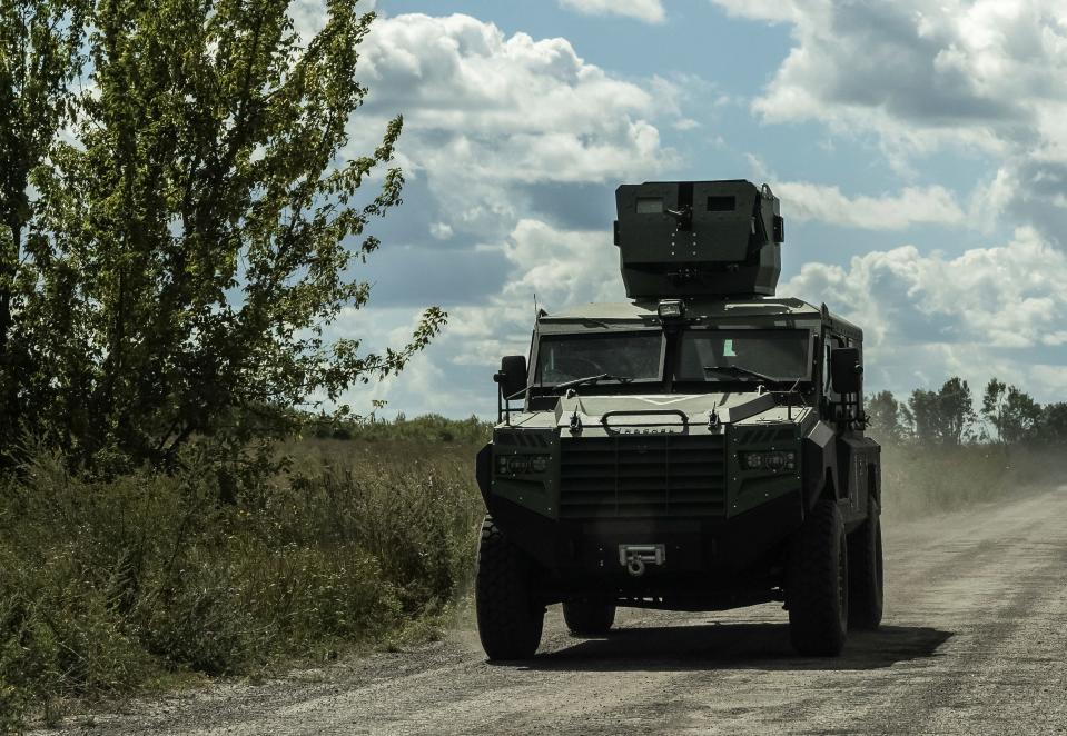 Ukrainian servicemen ride a military vehicle near the Russian border in Ukraine's Sumy region on August 12.