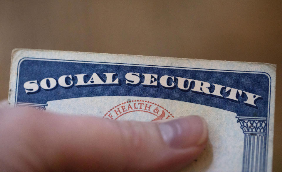 FILE - A Social Security card is displayed on Oct. 12, 2021, in Tigard, Ore. A growing number of older adults are in debt in retirement, according to the 2022 Survey of Consumer Finances from the Federal Reserve. Supplementing retirement savings and Social Security benefits with part-time earnings can make your money go further and help you pay off remaining debt. (AP Photo/Jenny Kane, File)