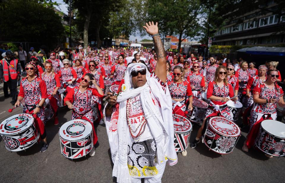 Participants pass through Westbourne Park during the adults parade, part of the Notting Hill Carnival celebration (PA)