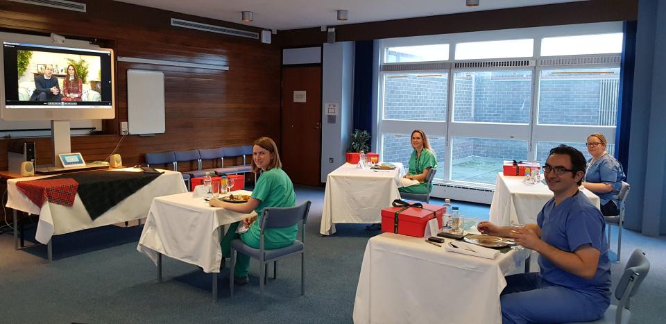 Staff eat while watching the messagePA