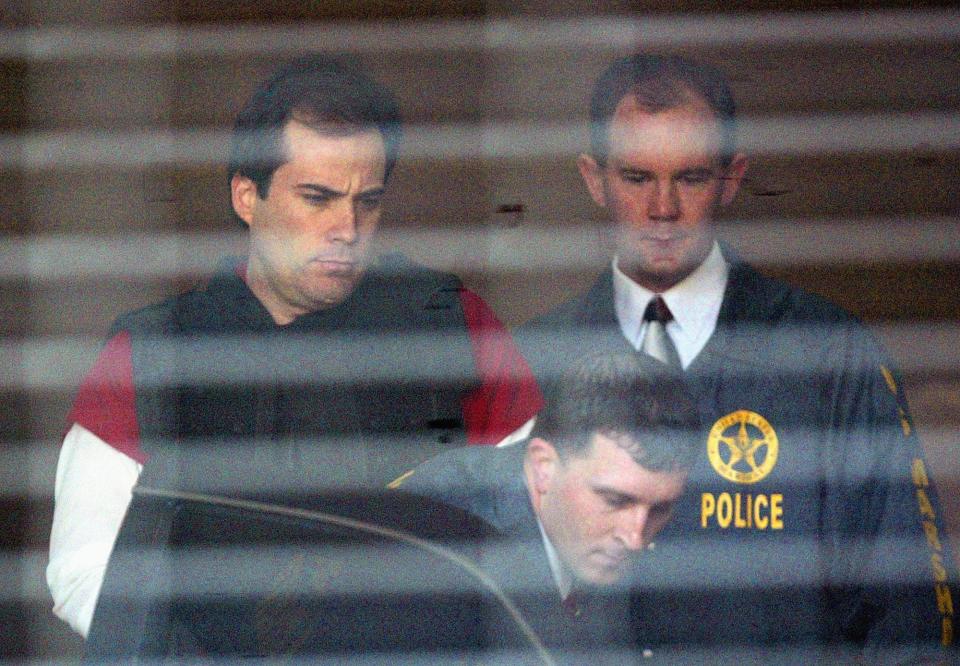 FILE - In this April 13, 2005, file photo, alleged bomber Eric Rudolph, left, is led to a waiting police car by U.S. Marshals as he leaves the Jefferson County Jail for a hearing in Birmingham, Ala. Rudolph, who disappeared into the mountains of North Carolina after he set off a deadly bomb at the 1996 Atlanta Olympics, was one of the hundreds of fugitives who have appeared on the FBI's Ten Most Wanted Fugitives list. He was captured five years after the Atlanta bombing. (AP Photo/John Bazemore, File)