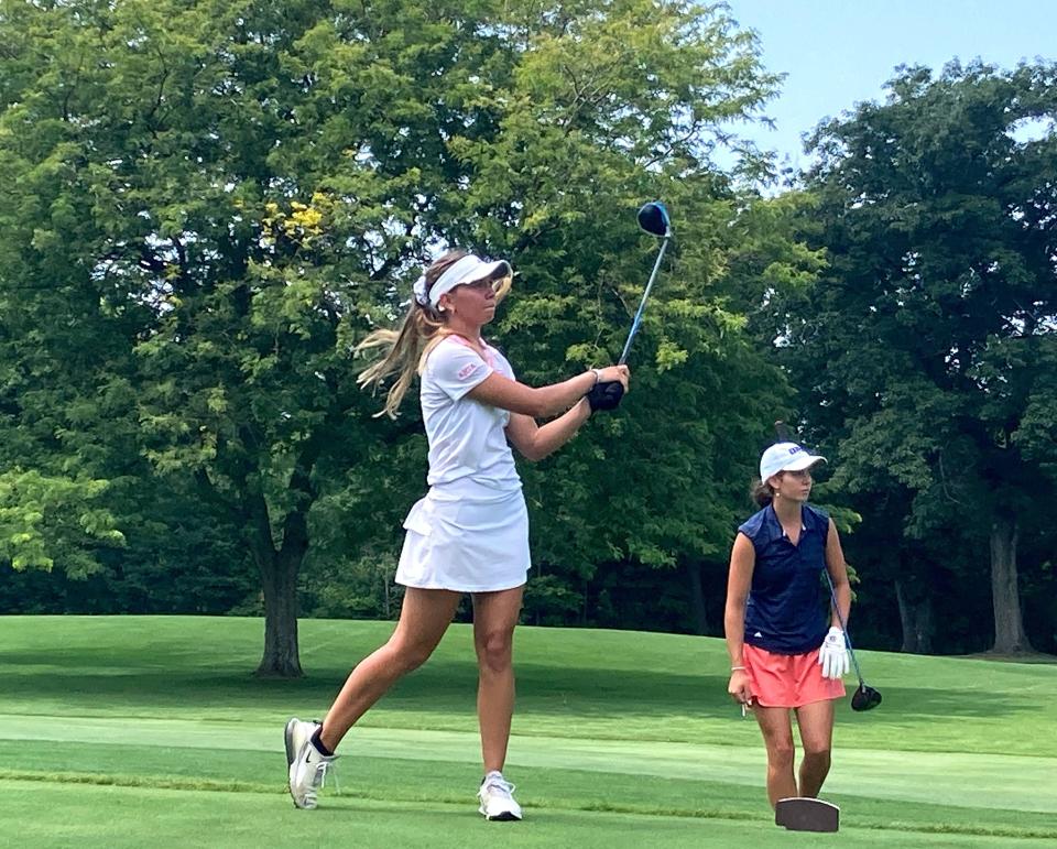 Anna Swan watches older sister Lydia Swan hit her tee shot on Lake View Country Club's fifth hole during their championship match Sunday in the Erie District Women's Golf Association Match Play Tournament. Anna Swan repeated as its champion with a 3 and 2 victory.