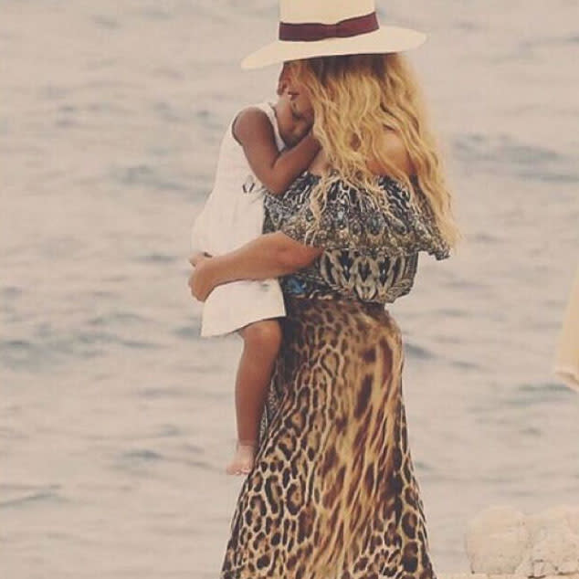 <p>Snuggling up to mom during a walk on the beach, Blue Ivy looks absolutely content. </p>