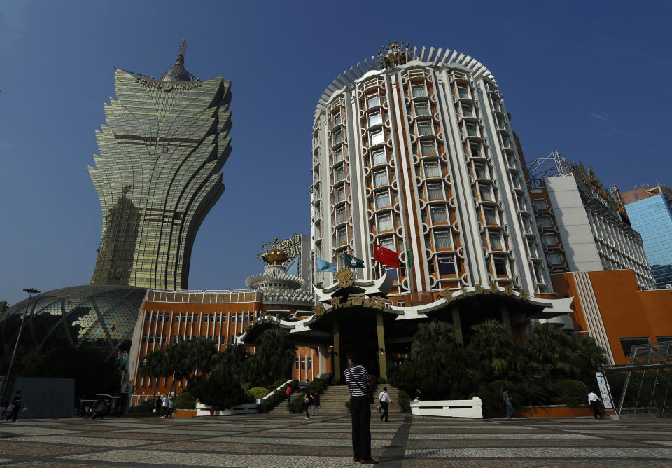 In this May 25, 2012 photo, the new, left, and old Casino Lisboa, right, are seen in Macau. Macau is in the midst of one of the greatest gambling booms the world has ever known. To rival it, Las Vegas would have to attract six times as many visitors essentially every man, woman and child in America. Wynn Las Vegas now makes nearly three-quarters of its profits in Macau. Sands, which owns the Venetian and Palazzo, earns two-thirds of its revenue there. (AP Photo/Vincent Yu)