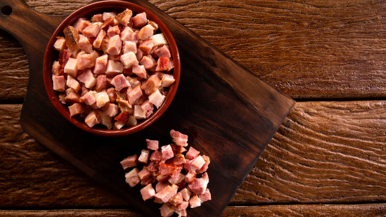 lardons in bowl, cutting board