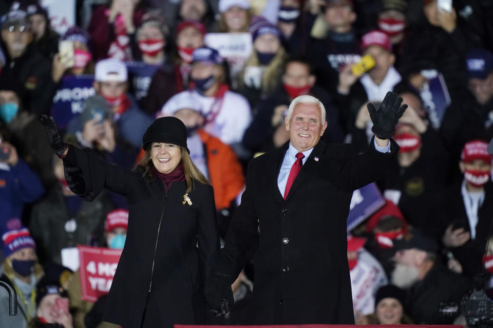 Vice President Mike Pence and his wife Karen wave before the vice president speaks during a campaign event, Monday, Nov. 2, 2020, in Grand Rapids, Mich. (AP Photo/Carlos Osorio)