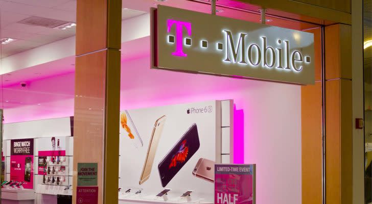 The logo for T-Mobile is displayed on a sign for an indoor retail storefront.