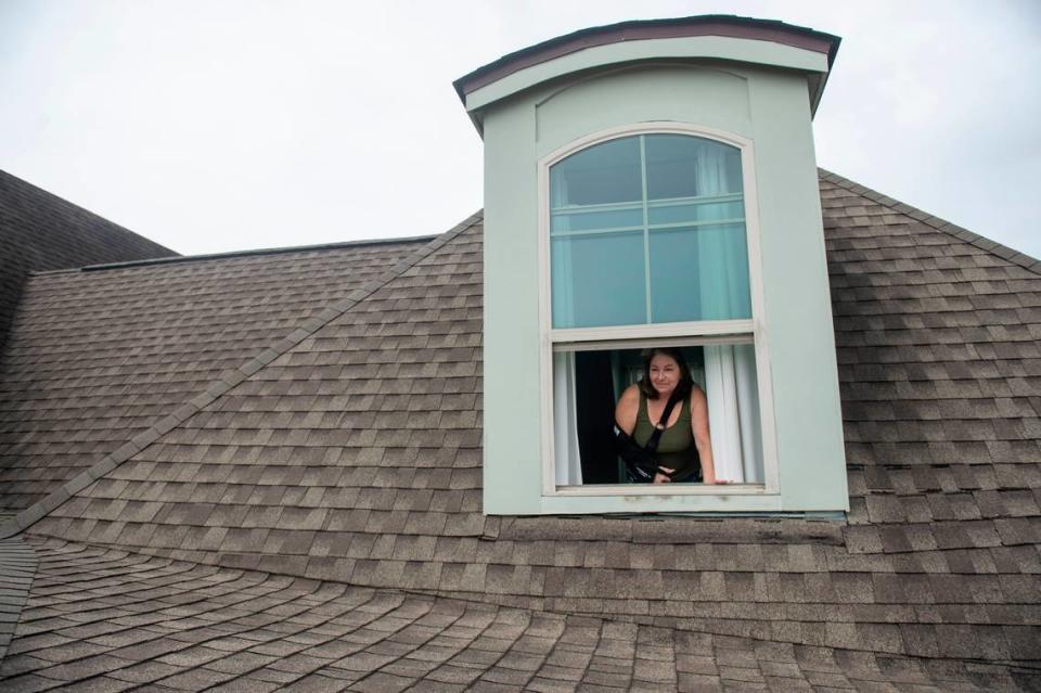 Teresa Teague looks out onto her roof at her home in Biloxi on Thursday, March 14, 2024. Teague won the house in the 2015 Mississippi Gulf Coast St. Jude Dream Home Giveaway and alleges that home builder Elliott Homes improperly installed a portion of the roof, leading to rot, leaks and termites.