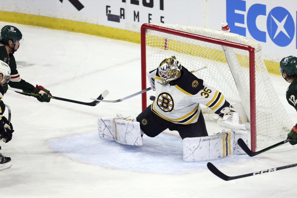 Minnesota Wild left wing Marcus Johansson, left, scores a goal against Boston Bruins goaltender Linus Ullmark (35) during the first period of an NHL hockey game Sunday, March 18, 2023, in St. Paul, Minn. (AP Photo/Stacy Bengs)