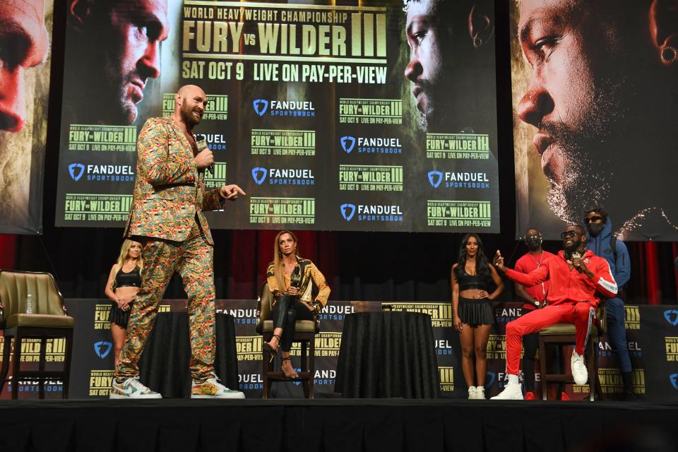 British boxer Tyson Fury (L) and challenger US boxer Deontay Wilder attend a press conference for their WBC heavyweight championship fight, October 6, 2021 at the MGM Grand Garden Arena in Las Vegas, Nevada ahead of their October 9, 2021 fight. (Photo by Robyn Beck / AFP) (Photo by ROBYN BECK/AFP via Getty Images)