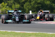 Mercedes driver Lewis Hamilton of Britain steers his car followed by Red Bull driver Max Verstappen of the Netherlands during the qualifying session for the Hungarian Formula One Grand Prix at the Hungaroring racetrack in Mogyorod, Hungary, Saturday, July 31, 2021. The Hungarian Formula One Grand Prix will be held on Sunday. (AP Photo/Darko Bandic)