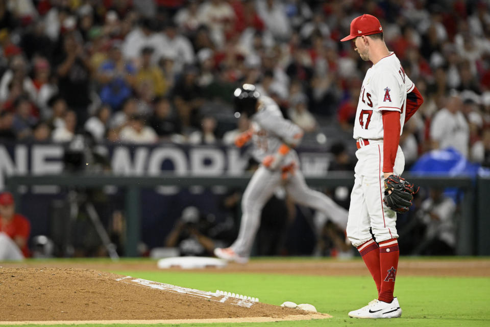 Los Angeles Angels starting pitcher Griffin Canning, right, waits as Detroit Tigers' Javier Baez rounds third on a solo home run during the fourth inning of a baseball game in Anaheim, Calif., Friday, Sept. 15, 2023. (AP Photo/Alex Gallardo)