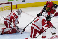 Detroit Red Wings goalie Jonathan Bernier, left, makes a save on a shot by Chicago Blackhawks center Carl Soderberg, right, during the third period of an NHL hockey game in Chicago, Saturday, Feb. 27, 2021. (AP Photo/Nam Y. Huh)