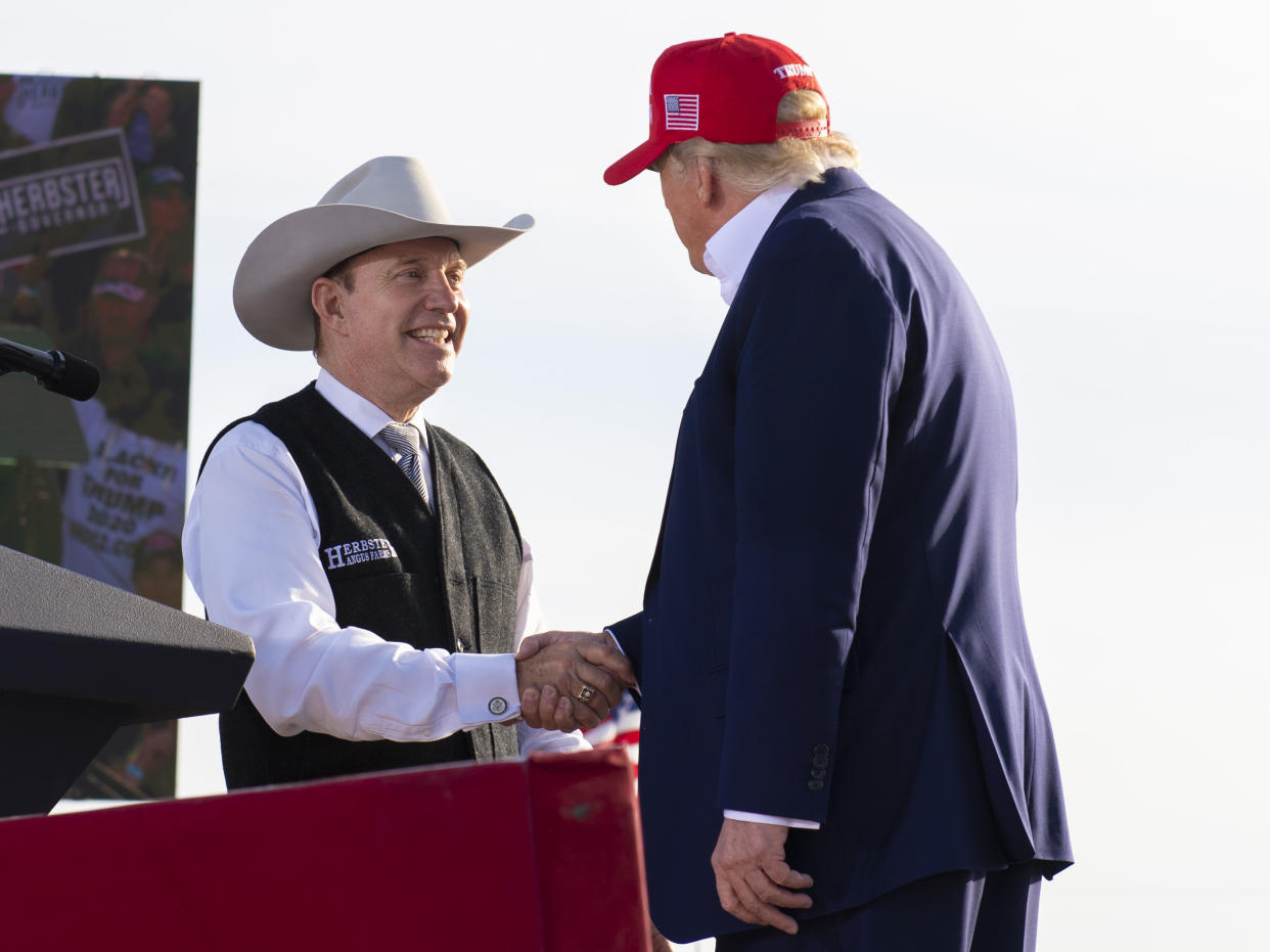 Nebraska Republican gubernatorial candidate Charles Herbster, left, shakes hands with former President Donald Trump during a campaign rally for Herbster, May 1, 2022, in Greenwood, Neb. (Kenneth Ferriera/Lincoln Journal Star via AP)