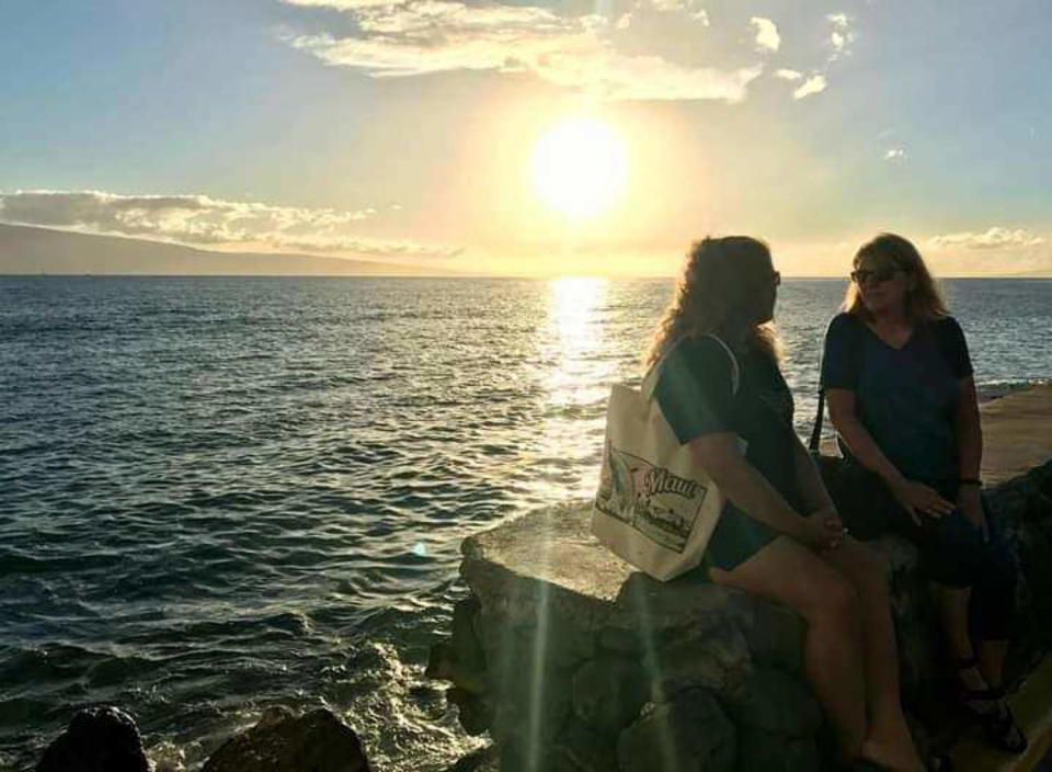 Annelise Cochran with her mother sitting on the exact sea wall she clung to that saved her life. (Courtesy Annelise Cochran)