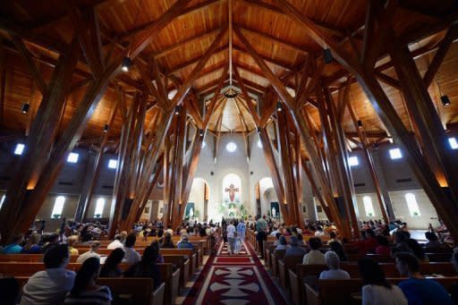 Parishioners at Our Lady of Loreto Catholic Church pray during morning mass remembering victims of the theater shooting in Aurora, Colorado. US President Barack Obama headed to Colorado on Sunday to meet victims of the cinema shooting massacre