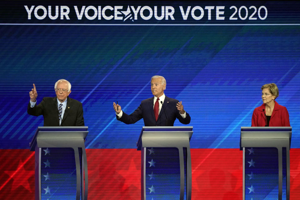 Sen. Elizabeth Warren, D-Mass., right, listens as Sen. Bernie Sanders, I-Vt., left, and former Vice President Joe Biden, right, speak Thursday, Sept. 12, 2019, during a Democratic presidential primary debate hosted by ABC at Texas Southern University in Houston. (AP Photo/David J. Phillip)