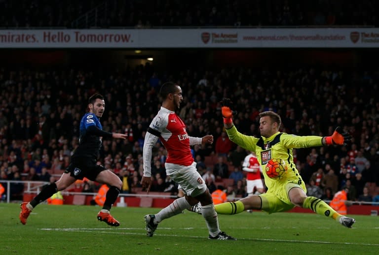 Bournemouth's Artur Boruc (R) makes a save from Arsenal's Theo Walcott during the match at the Emirates Stadium in London on December 28, 2015