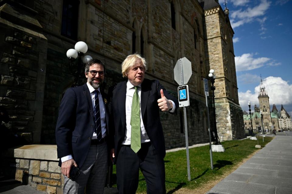 Former British Prime Minister Boris Johnson gives a thumbs up as he poses for a photo with Canadian Minister of Environment and Climate Change Steven Guilbeault (AP)