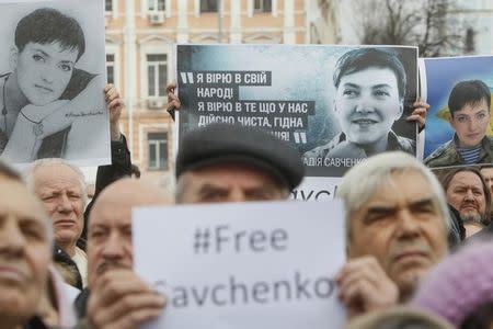 People hold portraits of Ukrainian army pilot Nadezhda (Nadia) Savchenko during a rally demanding her liberation by Russia, in central Kiev March 1, 2015. REUTERS/Valentyn Ogirenko/Files