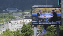 A TV screen shows a photo of South Korean President Moon Jae-in and North Korean leader Kim Jong UN, right, to advertise upcoming Seoul Defense Dialogue in Seoul, South Korea, Wednesday, Sept. 5, 2018. A South Korean presidential delegation met with North Korean officials Wednesday for talks to arrange a summit planned later this month and help rescue faltering nuclear diplomacy between Washington and Pyongyang.The sign read: "Peace on the Korea peninsular." (AP Photo/Ahn Young-joon)