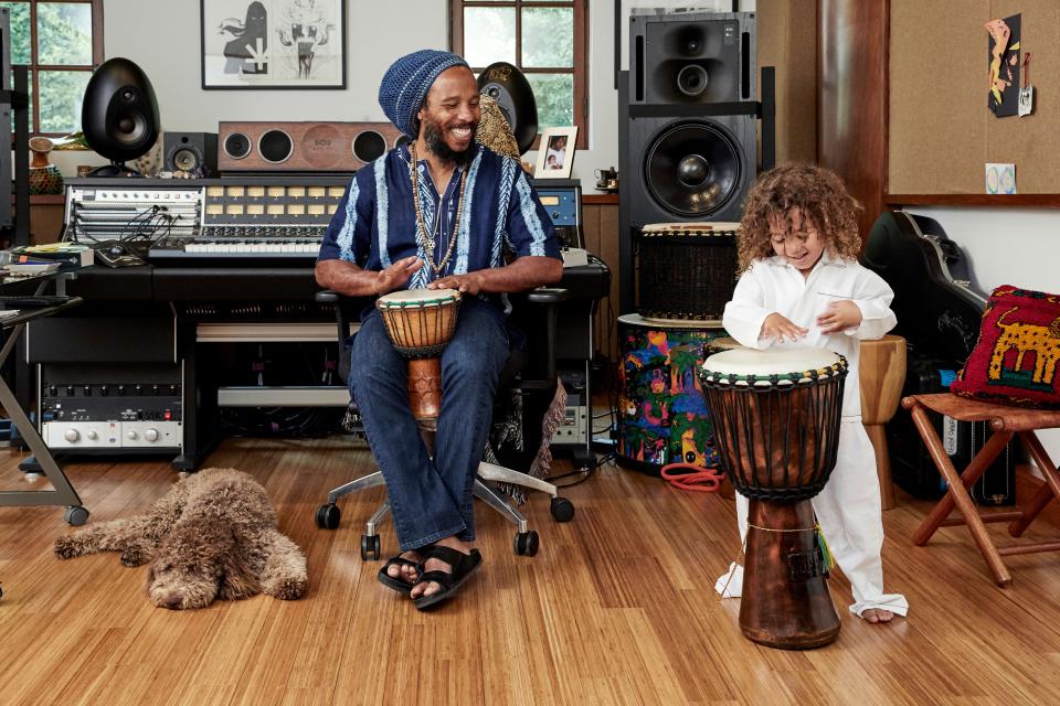 Musician Ziggy Marley in his home recording studio in L.A.’s Toluca Lake neighborhood with son Isaiah and dog Romeo. The room was originally a movie screening room for the previous owners.