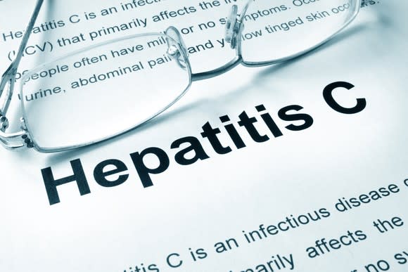 Paper with definition of hepatitis C with eye glasses on it