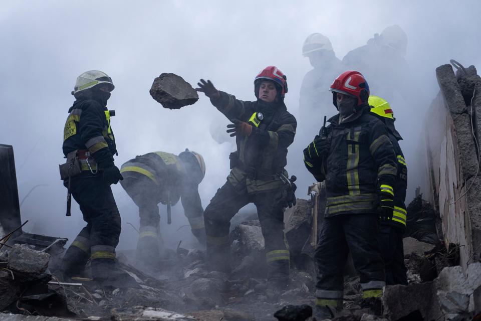 Rescue workers clear rubble from the apartment building following Russian strike (Copyright 2020 The Associated Press. All rights reserved)