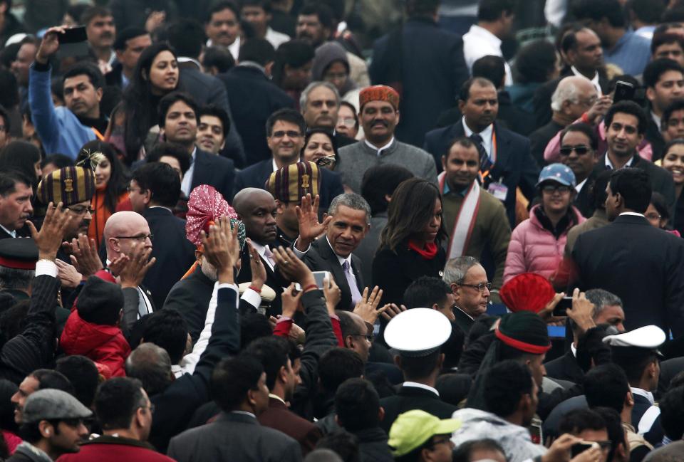 U.S. President Obama flanked by the first lady Michelle, waves after attending the Republic Day parade in New Delhi