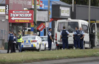 Police stand outside a mosque in Linwood, Christchurch, New Zealand, Friday, March 15, 2019. Multiple people were killed during shootings at two mosques full of people attending Friday prayers. (AP Photo/Mark Baker)